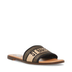 Flat women's sandal with fabric upper and slip-on design in neutral tones and subtle text on strap