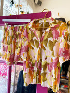 Floral patterned sheer short sleeve top and matching stretch smocked shorts in pink, yellow, and green tones.